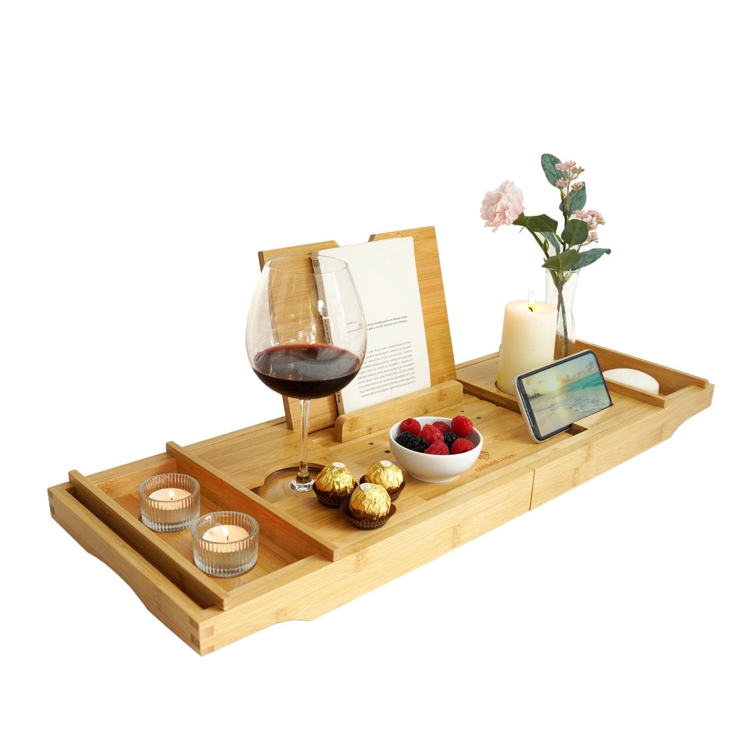 Bath caddy styled with a glass of red wine, lit candle, flowers and berries