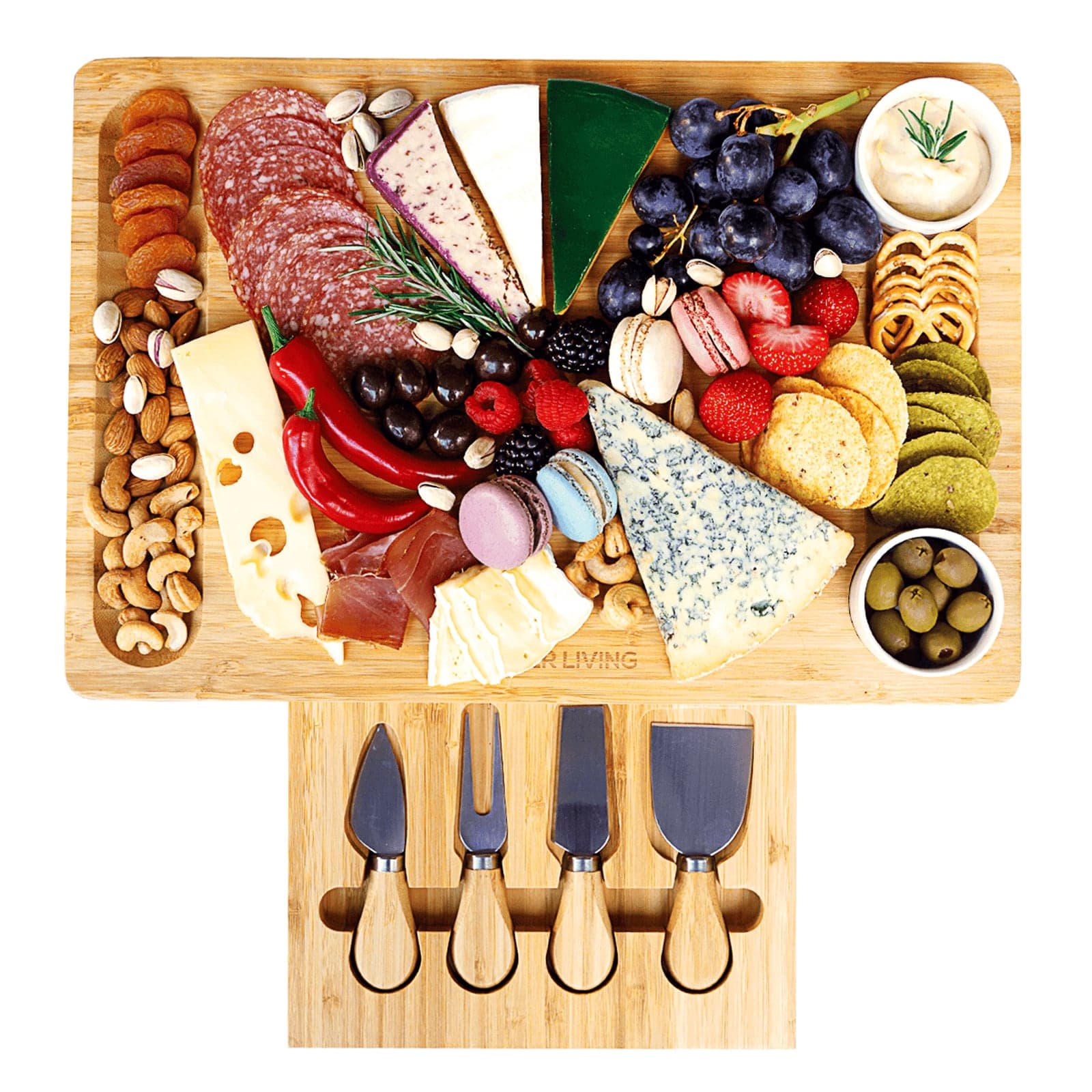 Overhead cheese board with salami, three cheeses, grapes, blackberries and olive dip
