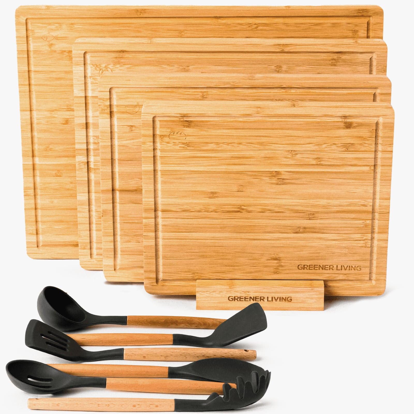 Four nested bamboo cutting boards fanned out with kitchen utensils on a white background