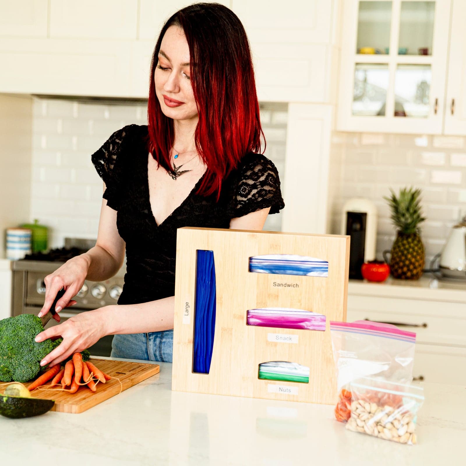 Woman preparing food in a bright kitchen with the bamboo organiser on the bench
