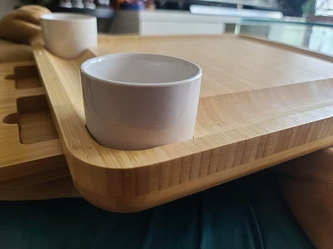 Customer close-up photo of a round ceramic bowl set into the cheese board