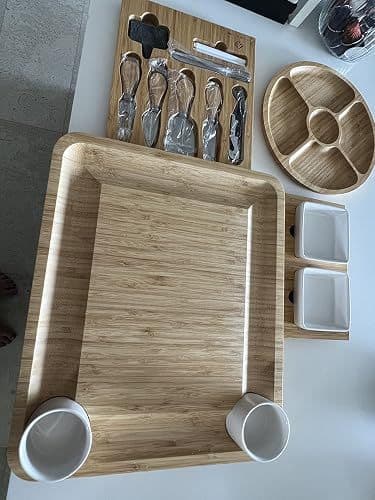 Customer overhead photo of the full cheese board set unboxed, including the tray, knife set and serving bowls