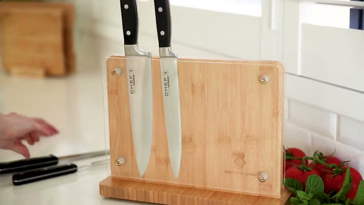 The bamboo knife block on a kitchen bench holding two chef's knives