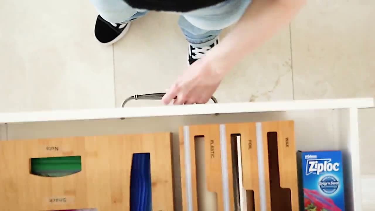 Overhead view of the bamboo organiser in a drawer, filled with sealed bags