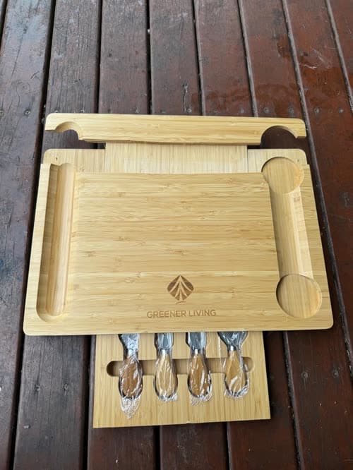 Customer photo of the board and its knife set on an outdoor timber table