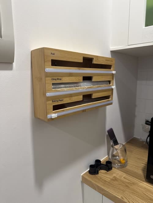 Customer photo of the dispenser mounted on a kitchen wall beside a timber benchtop